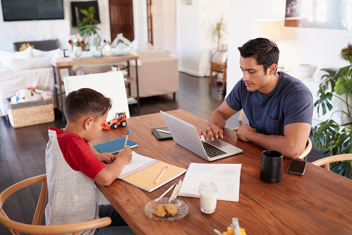 A father provides homeschooling with his son.